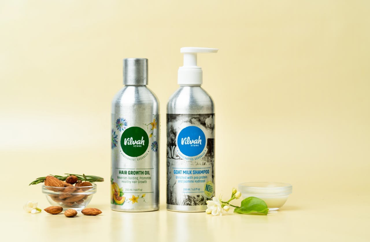 Natural hair care products featuring goat milk shampoo and hair growth oil on a yellow background.